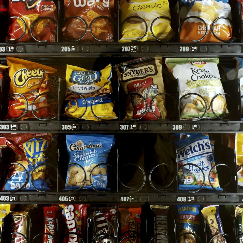 This Saturday, Sept. 7, 2019 photo shows items in a vending machine in New York. Americans are addicted to snacks, and food experts are paying closer attention to what that might mean for health and obesity. (AP Photo/Patrick Sison)